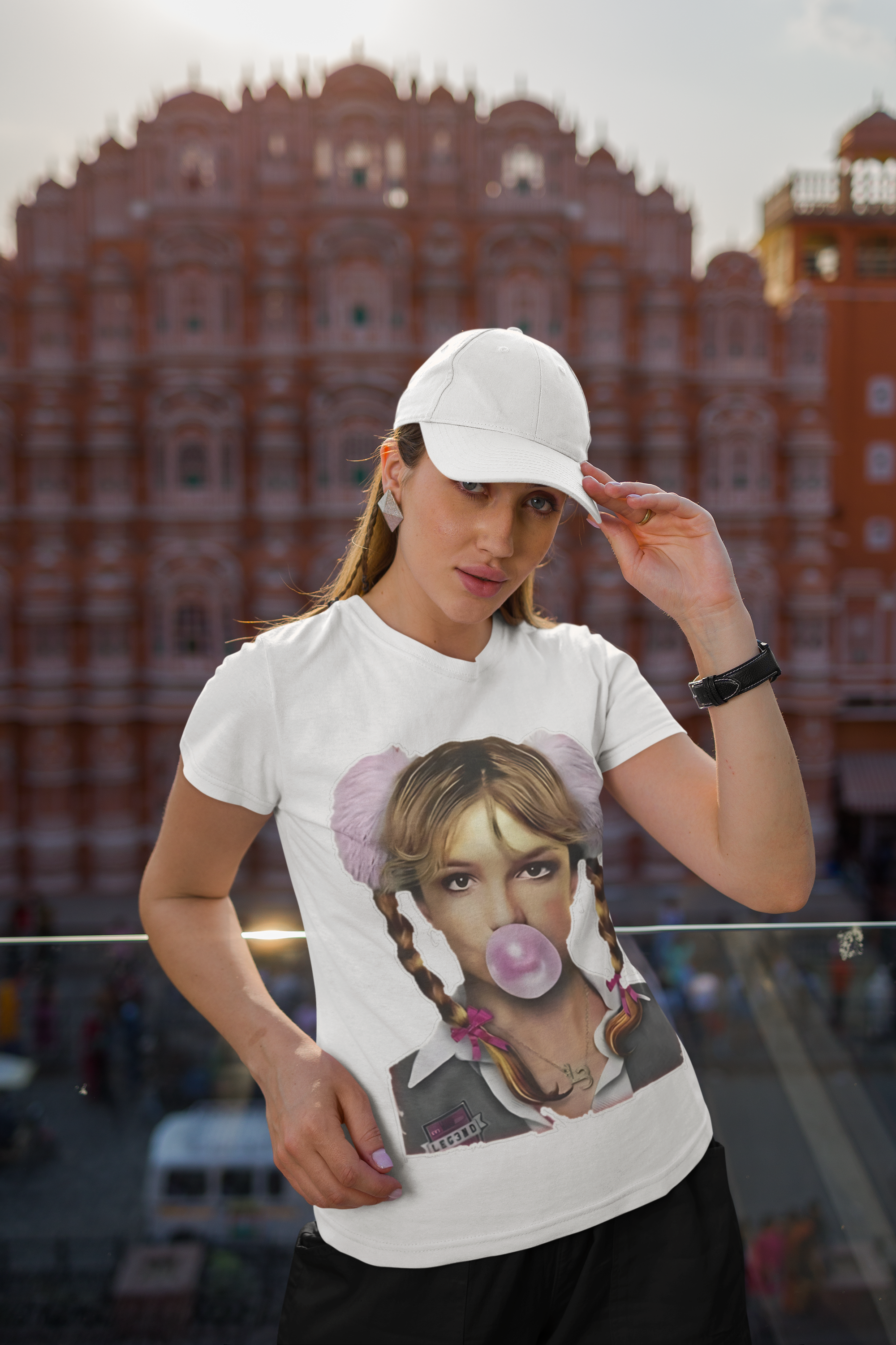 gildan-round-neck-t-shirt-and-dad-hat-mockup-of-a-woman-posing-against-a-balcony-m34695